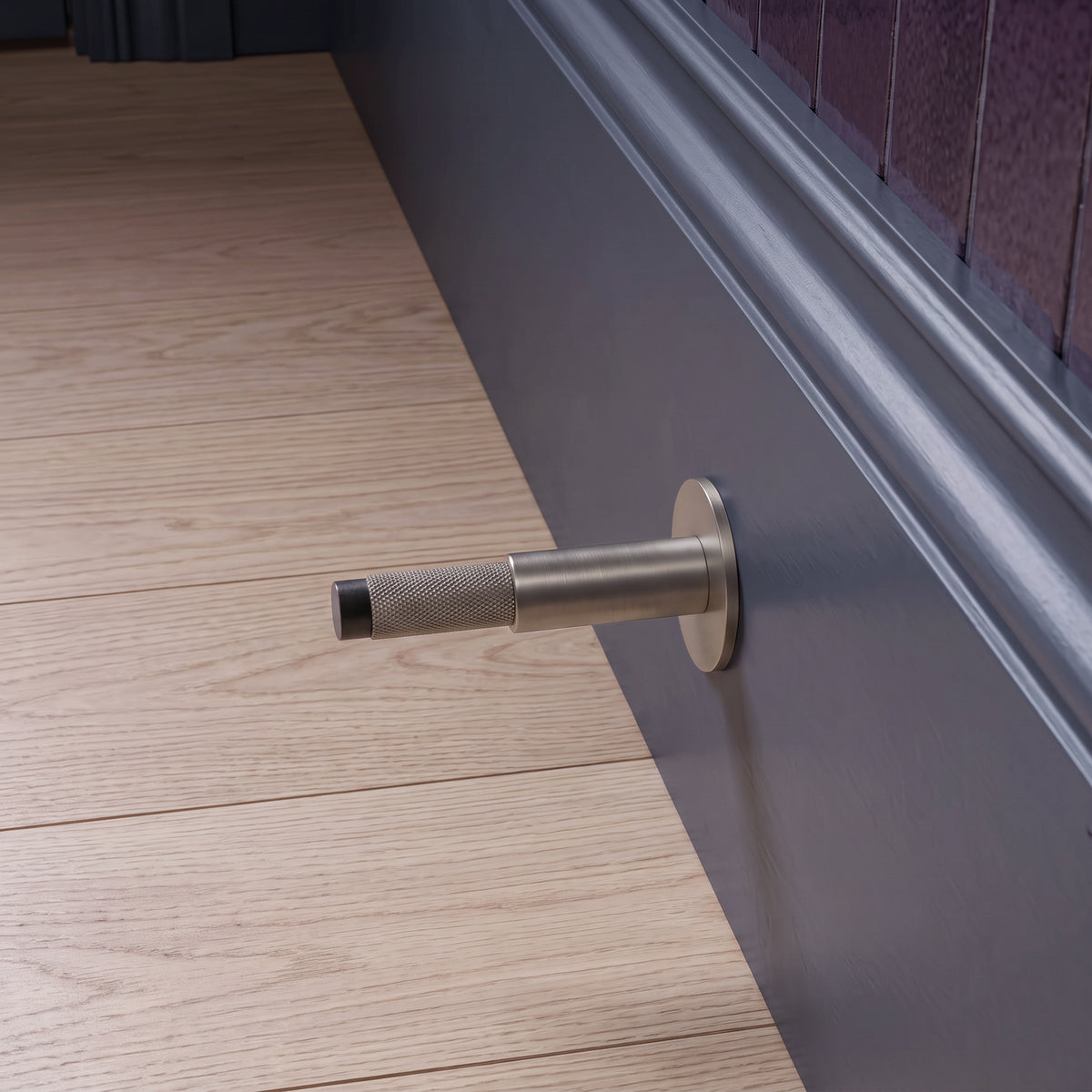 Halo Door Stop in Matte Satin Nickel installed on a timber floor