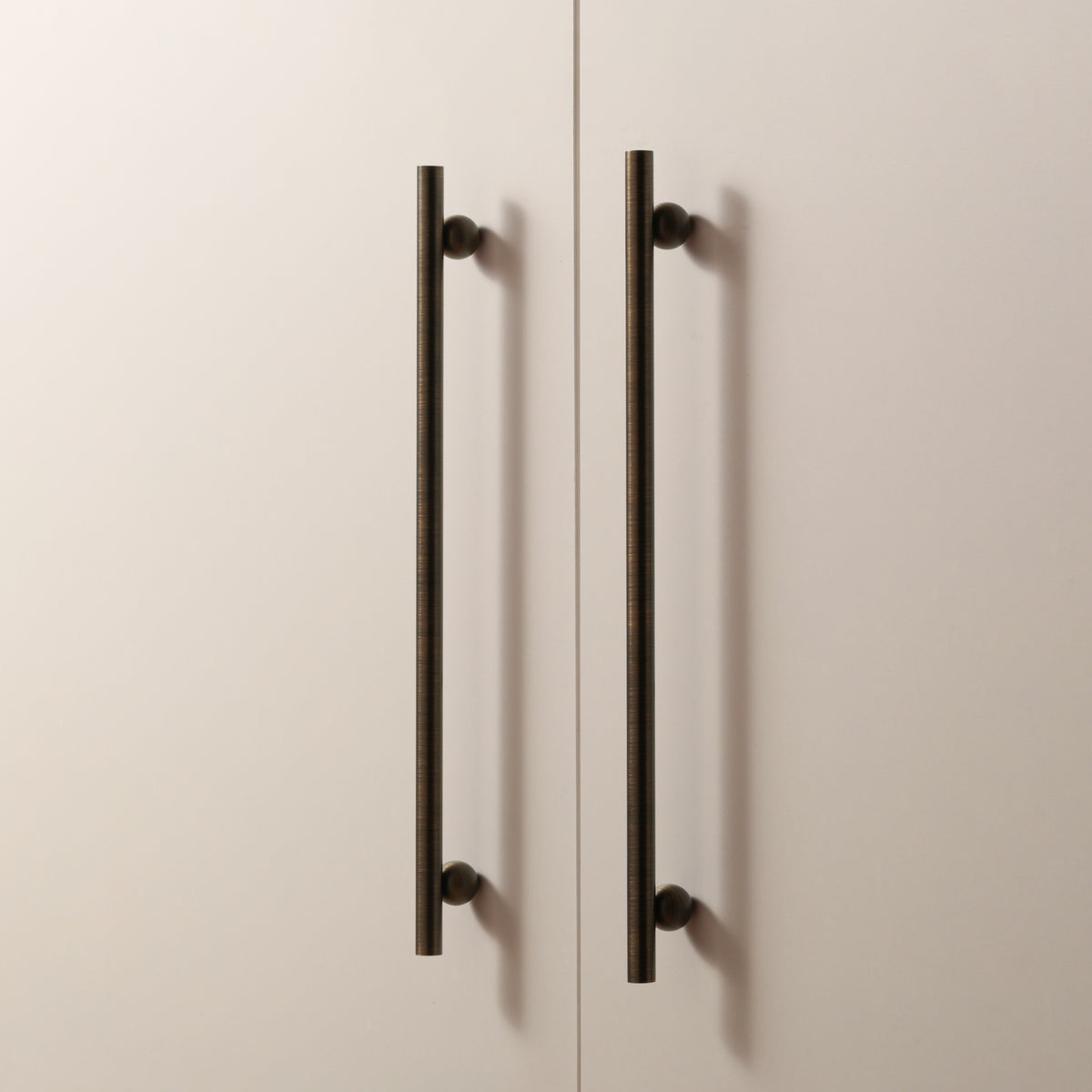 Flair Handle in Antique Brushed Bronze installed on cabinet doors