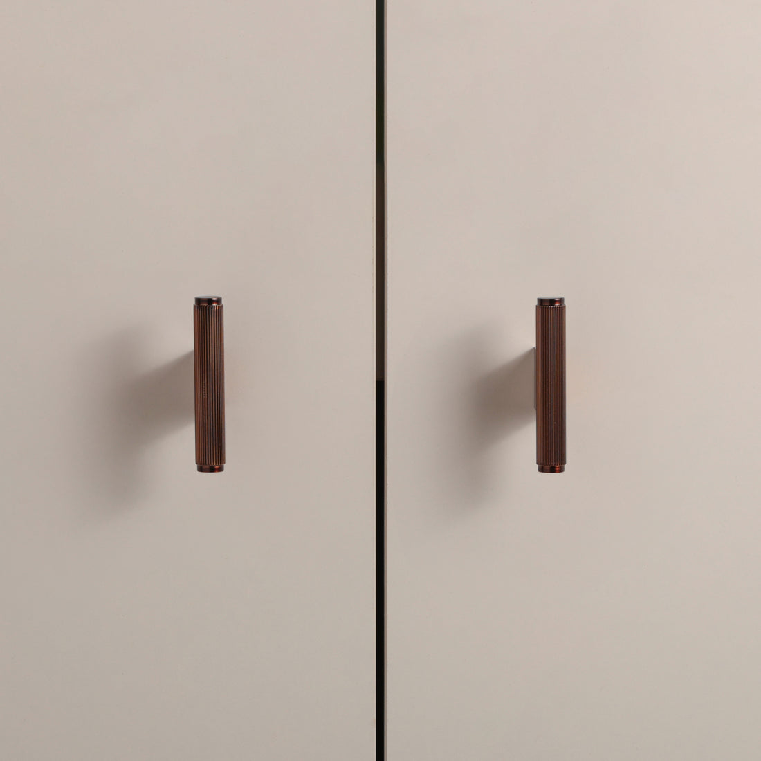 Stripe Knob in Copper Brass installed on cabinet doors