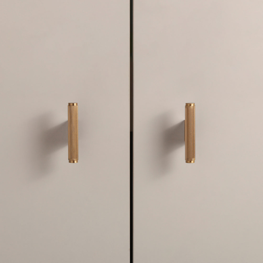 Stripe Knob in Satin Brass installed on cabinet doors