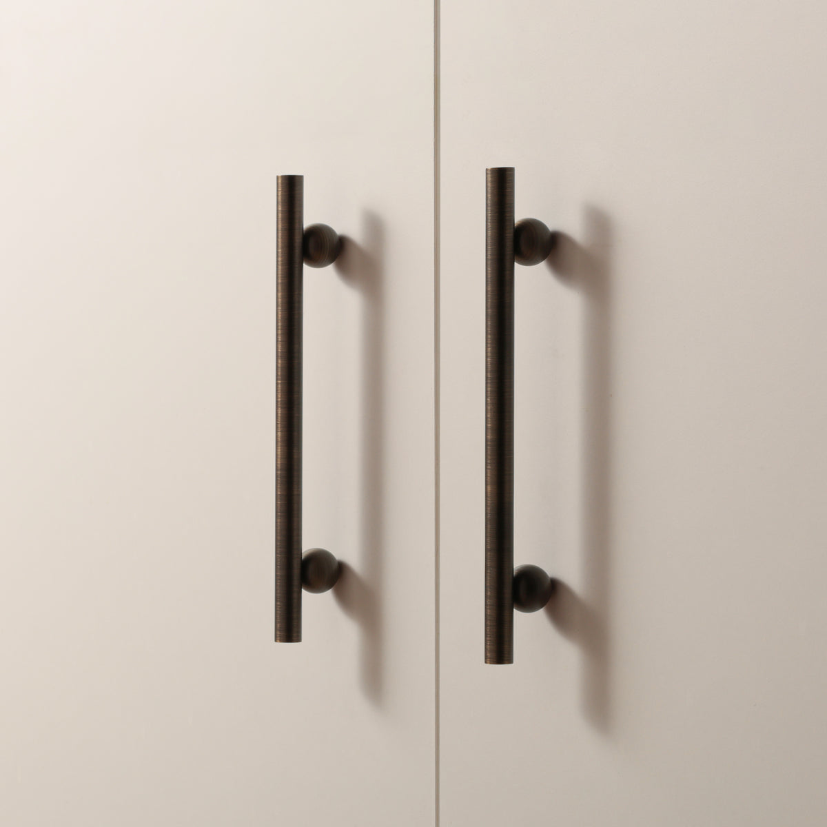 Flair Handle in Antique Brushed Bronze installed on cabinet doors